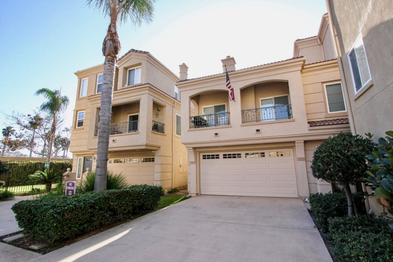 American flag flying from a three story town home inside the Sea Breeze Beach Cottages in Oceanside CA