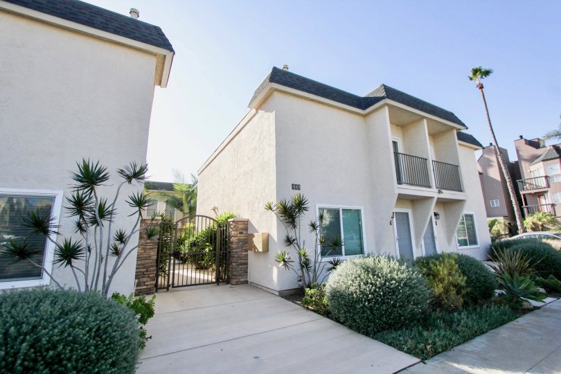 Two story house with gated back yard and patio with railings in Six Palms, in the city of Oceanside, California.