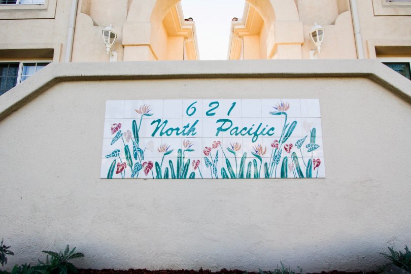 A sunny day in the area of Villa Pacific, welcome sign, outside, flowers, stairs, windows