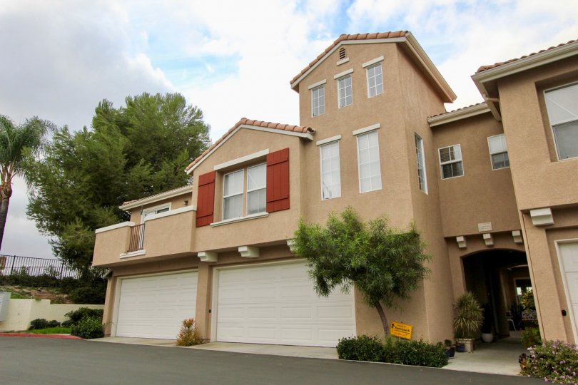 A two story property with two garages and an arched entryway at Vista Monte
