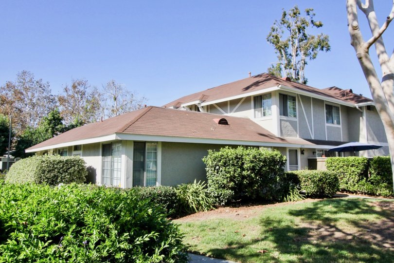A stately home surrounded by sprawling gardens full of green grass and trees at Whelan Ranch, Oceanside, California