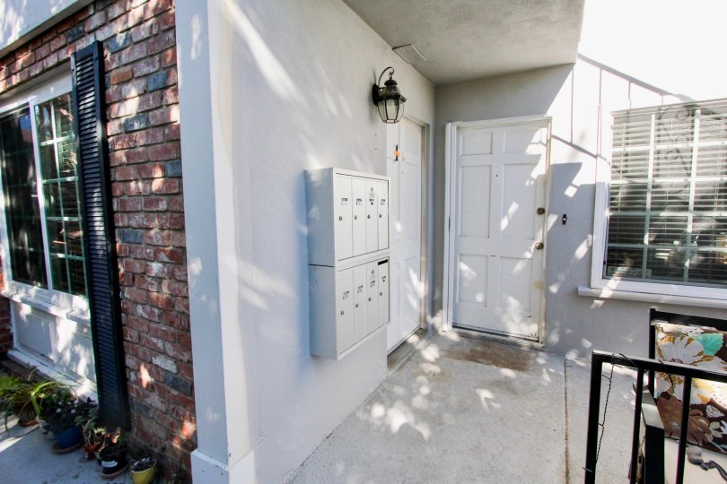 THE BUILDING IN THE 839 SAPPHIRE WITH THE ELECTRIC BOX, GLASS WINDOW, LAMP, PLANTS