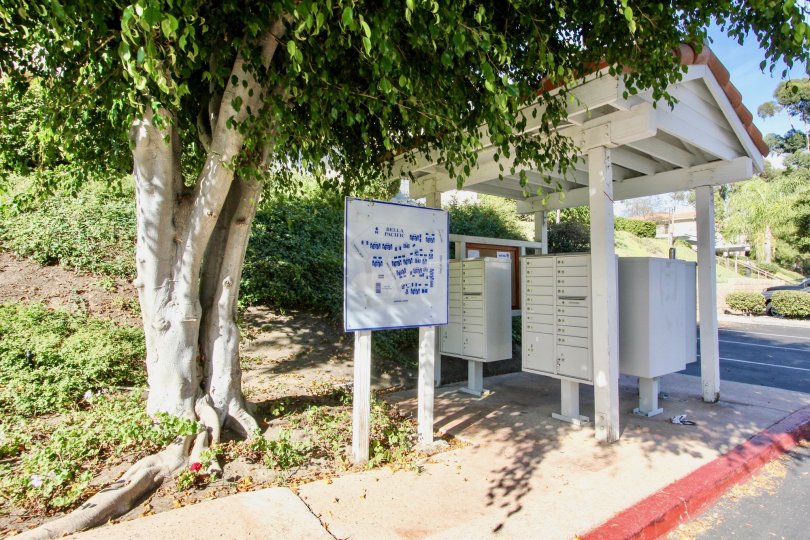 The Bella Pacific entry side with aname board and trees around
