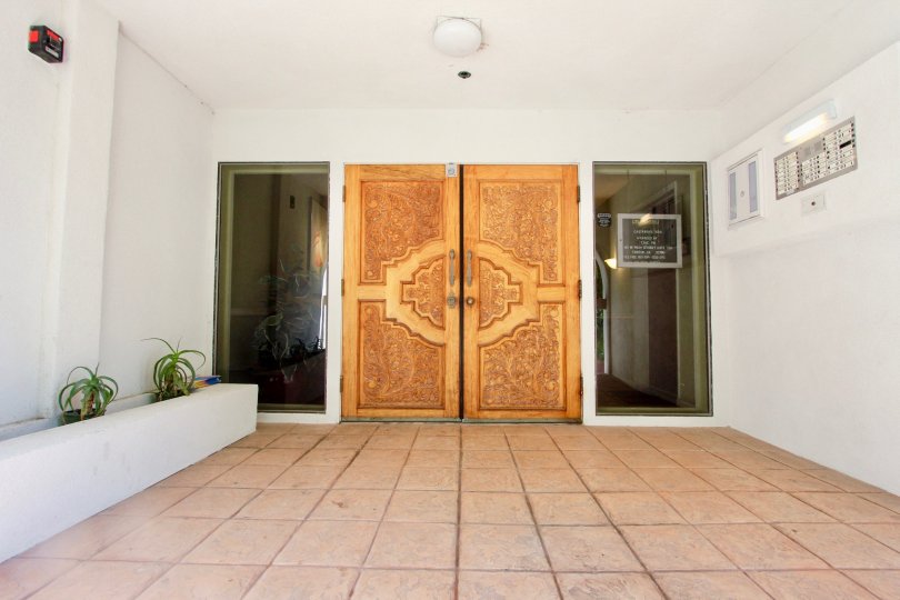 Ornate decorative entrance doors with large side windows at Castaway