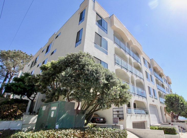 A four-storey townhouse with plain windows and glass railings in the Castaway community.