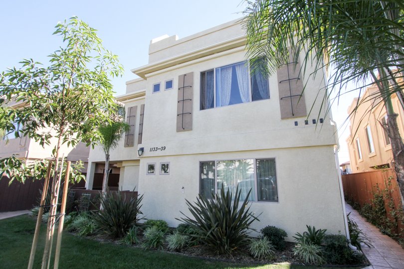 The Apartment in Felspar Townhomes mentioned wtih 1133-39 with bushes and trees