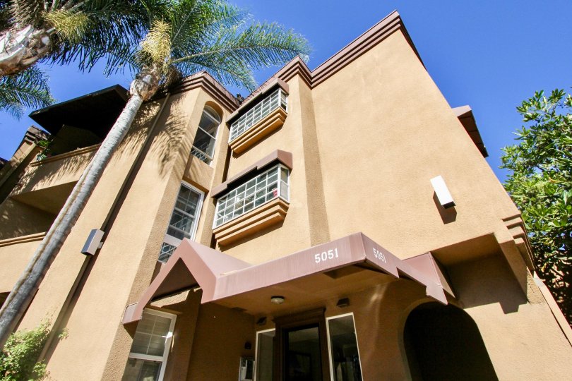 A sunny day in La Jolla Bella with villa with portigo and trees around in Pacific Beach