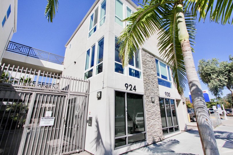 The apartment 924, 930 has glass windows and with trees in front of it