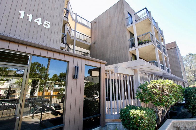The exterior of a residential apartment building on a sunny day.