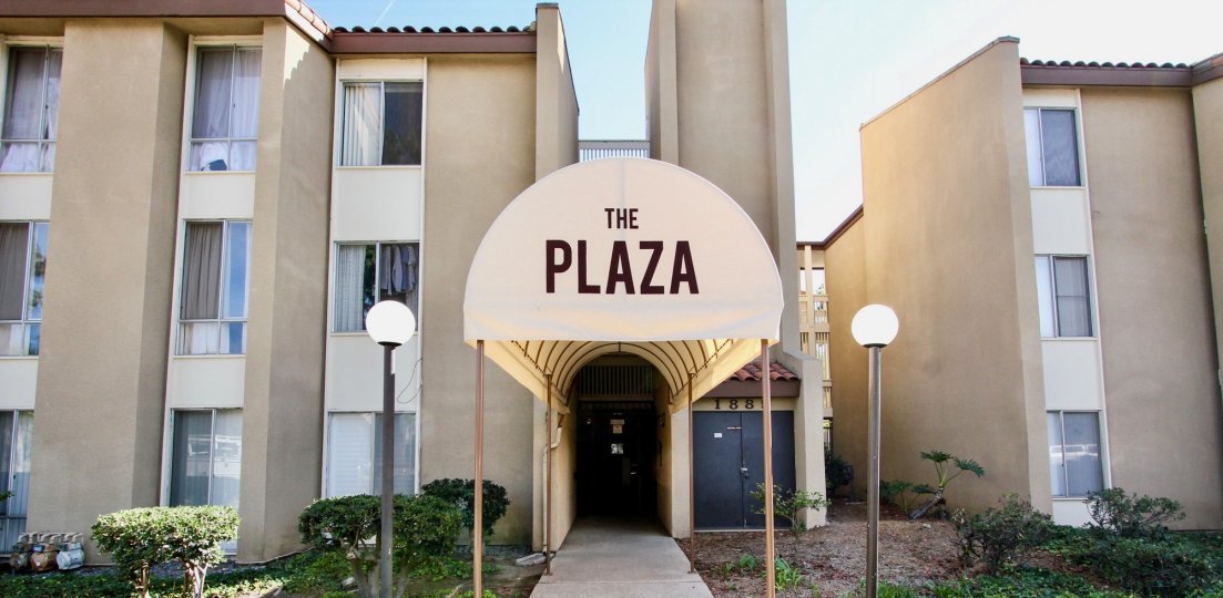 An entrance of a building in the The Plaza with beautiful plants.