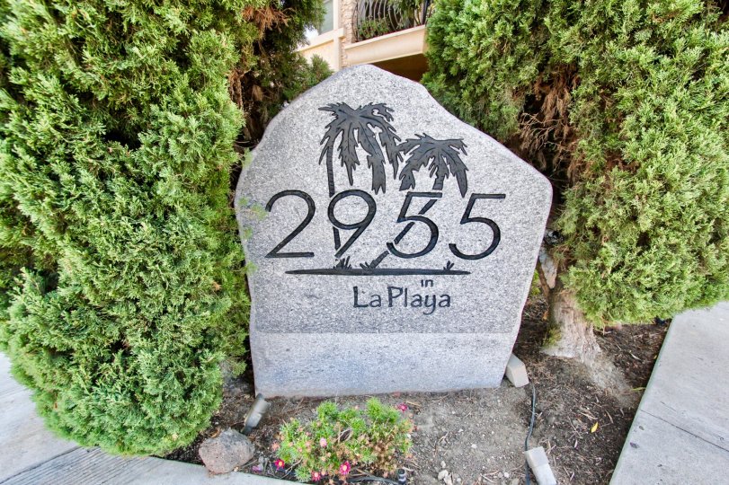 Large decorative address stone surrounded by well kept trees in Point Loma