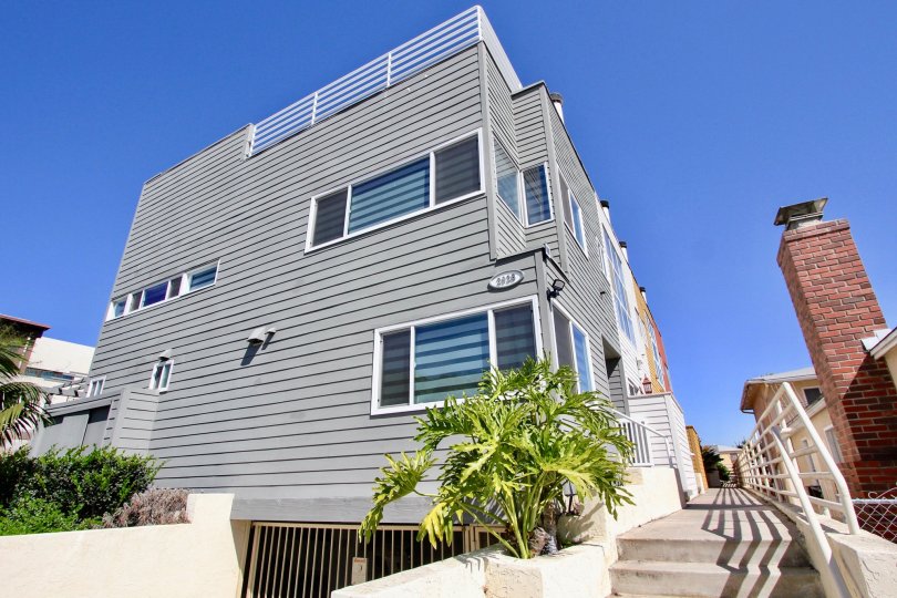 A corner unit with nice landscaping on a sunny day in the Harbor View Townhomes, Point Loma, CA