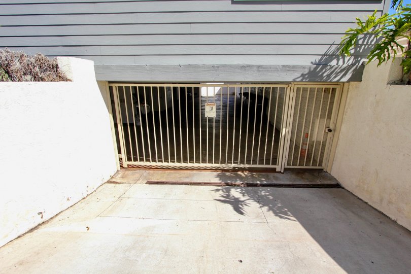 View of gated parking garage at Harboe View to homes on a sunny day