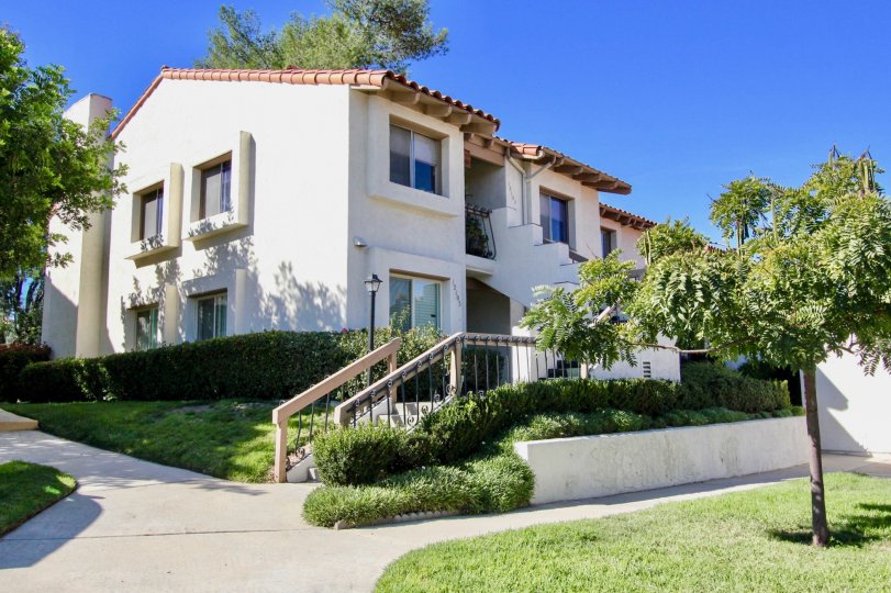 A sunny day in campana Villas with trees and grass with plesant