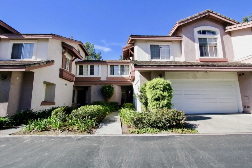 A sunny day in the Collage community in Rancho Bernardo with houses and plants.