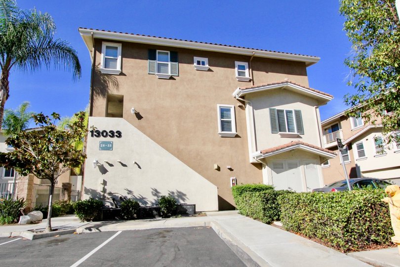 On morning, A villa in a front view with 13033 number and parking a car in front of the door