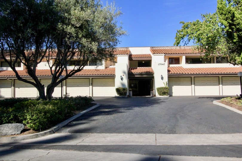 The Villa in the Oaks North Village marked as 17647 has long trees and grasses