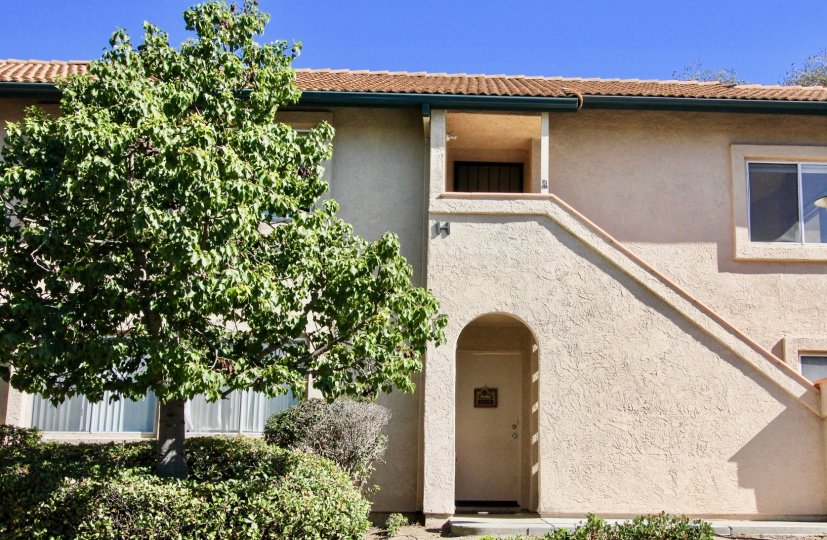Two story residence with trees & bushes inside The Falls in Rancho Bernardo CA