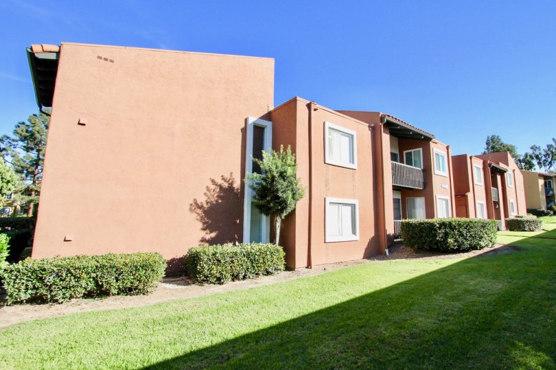 Two story red units with grass field inside the Waterbridge Community in Rancho Bernardo CA