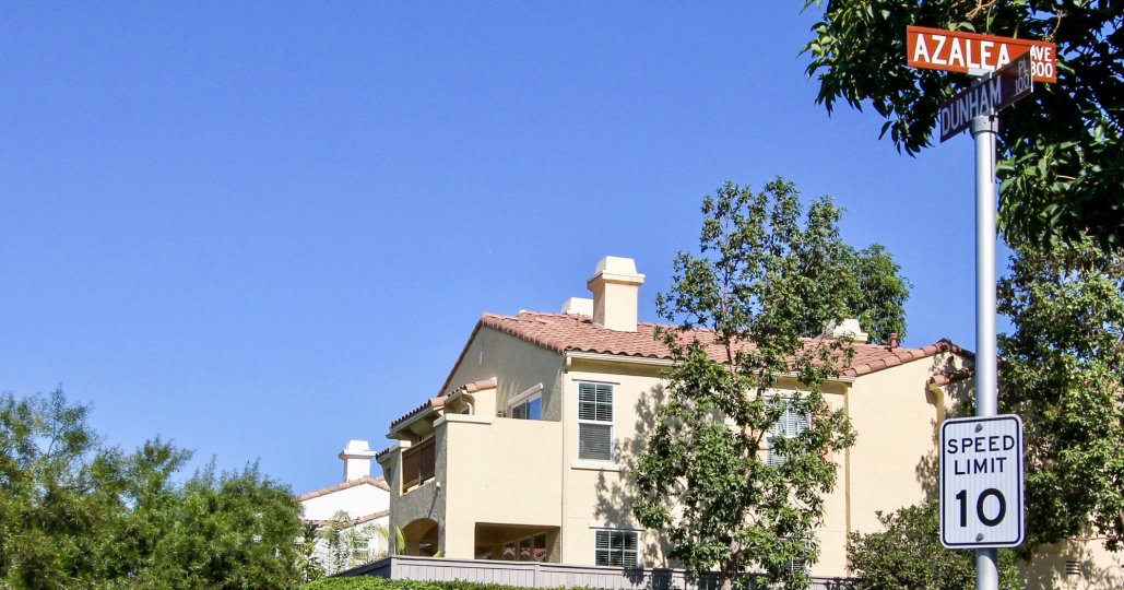 A traditional two-storey residence with a sign post in the Campana community.