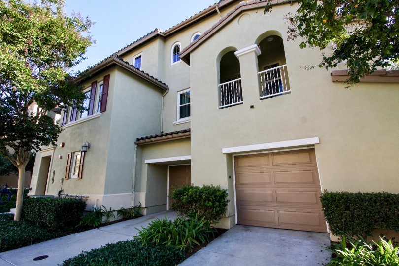 Three story condominiums with plants and trees inside Larkspur Heights at San Marcos CA