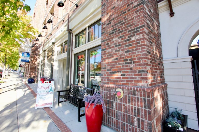 Brick chimney next to a store with glass windows at MarketWalk in San Marcos CA