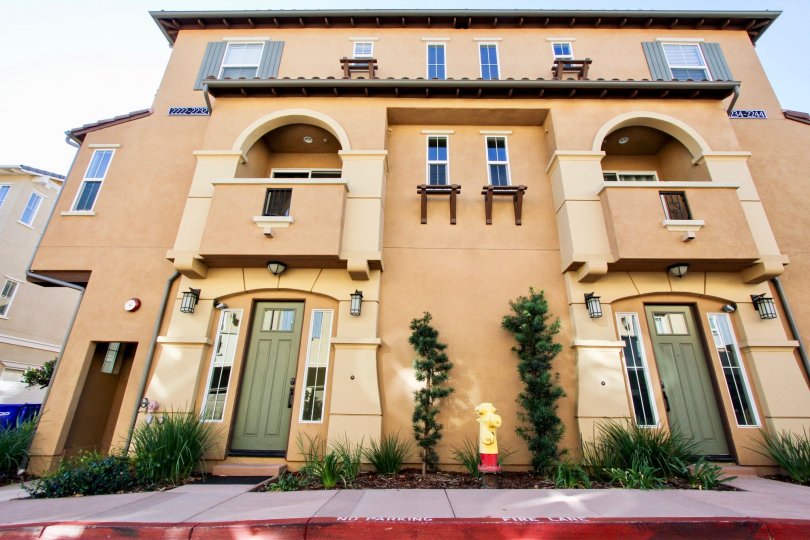 Three story building with green artistic doors in Solaire in San Marcos CA