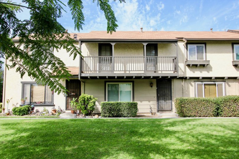 Two story apartments behind a green yard in the Magnolia Meadows in Santee California