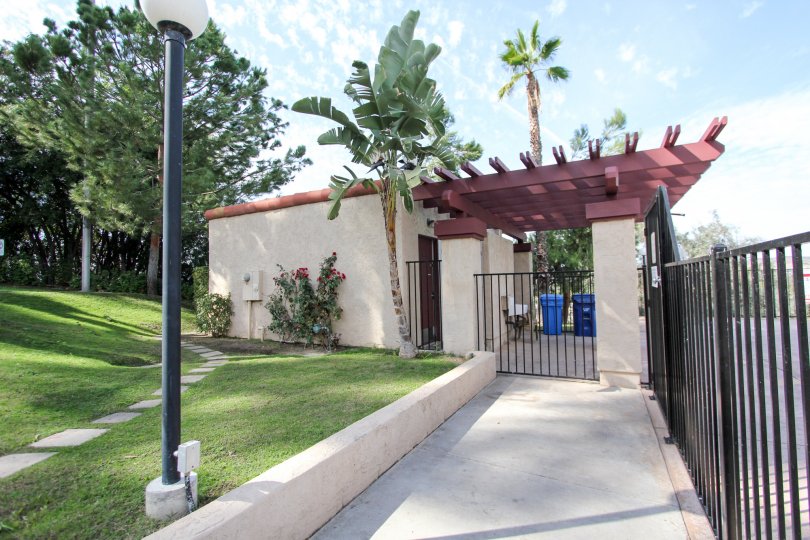 A gateway with palm trees and manicured lawn in Riderwood Terrace