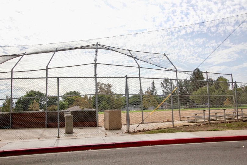 A sunny day in the area of Riderwood Village, baseball diamond, fence, water fountain