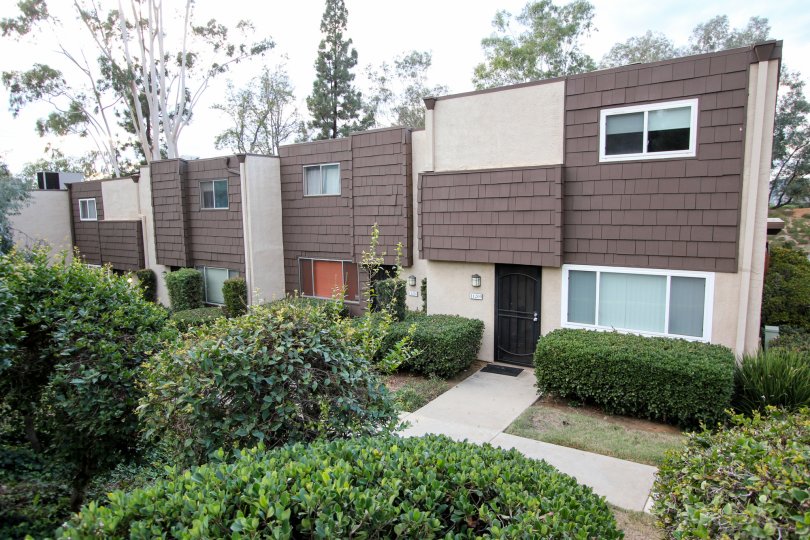 Rio Terrace,: Santee  , California,trimmed bushes,brown and white building