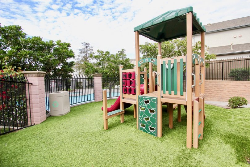 A sunny day in the area of Ashford Park, outside, playground, pool, fence, grass