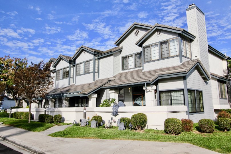 A large condo in the Cambridge Terrace community with multiple windows and a well-kept garden in front at University City, California
