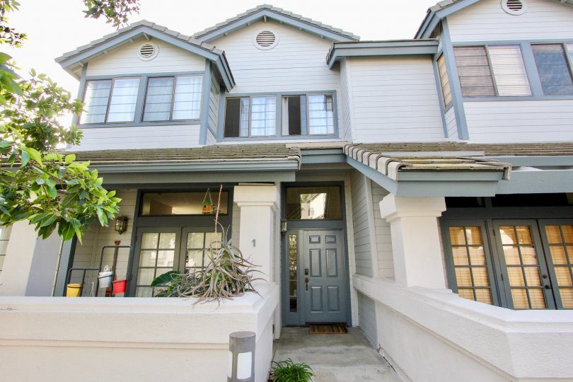 Traditional cottage styling townhome with siding and privacy walls at Cambridge Terrace