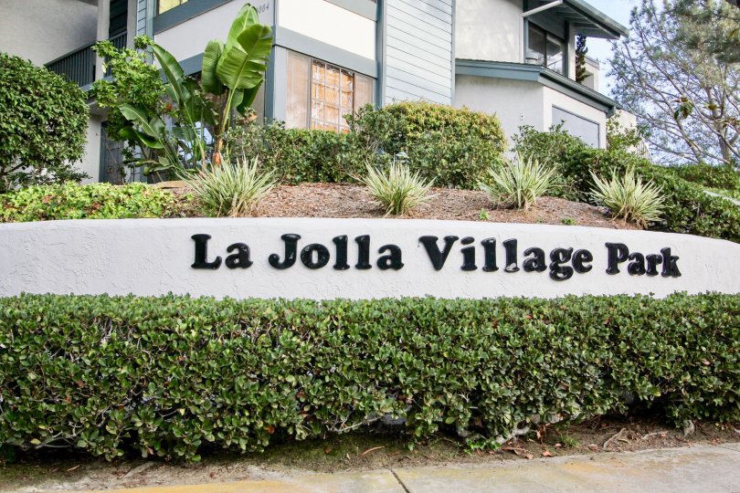 The sign at the entrance of La Jolla Village park showing the location name with attractive landscaping.