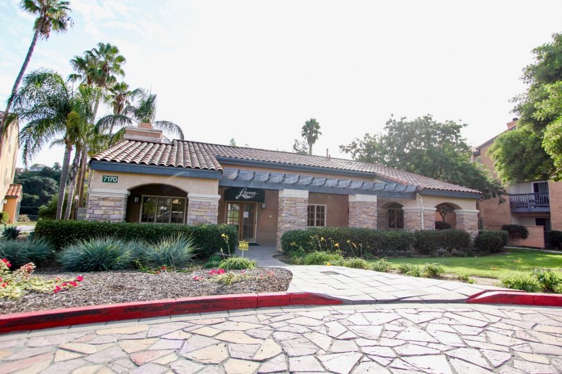 Single story home at the end of a driveway of stone in University City CA at Lucera