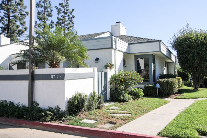 Curbside picture of home with white walls and blue trimming in Vista, CA