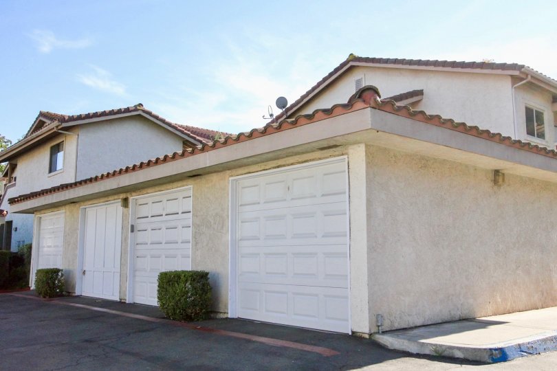 Rear garage and private parking area of condo complex in Shadowridge Glen.