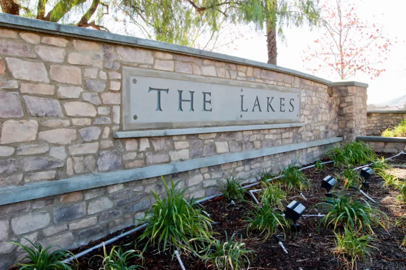 Well lit sign at the entrance of The Lakes in Menifee Ca