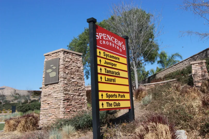 Perched atop an embankment as you enter the community you will see the graphic for Spencers Crossing