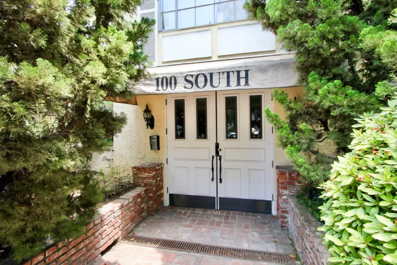 The entrance to 100 S Wetherly cozily fit in between trees and plants.