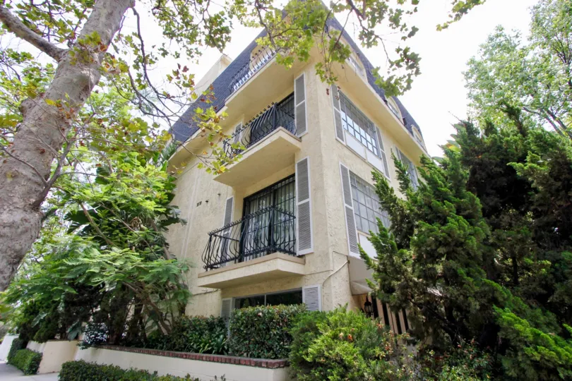 Three story apartment with wrought iron balcony and largeand glass