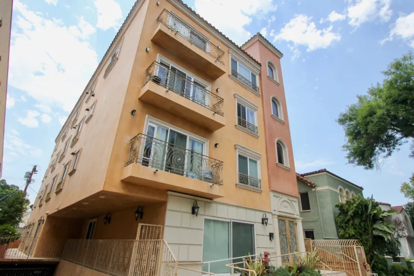 An upward view of the front of a four story building of 8420 Blackburn