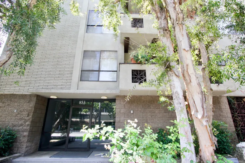 Entrance to 853 Le Doux with landscaping and first second floor unit balconies