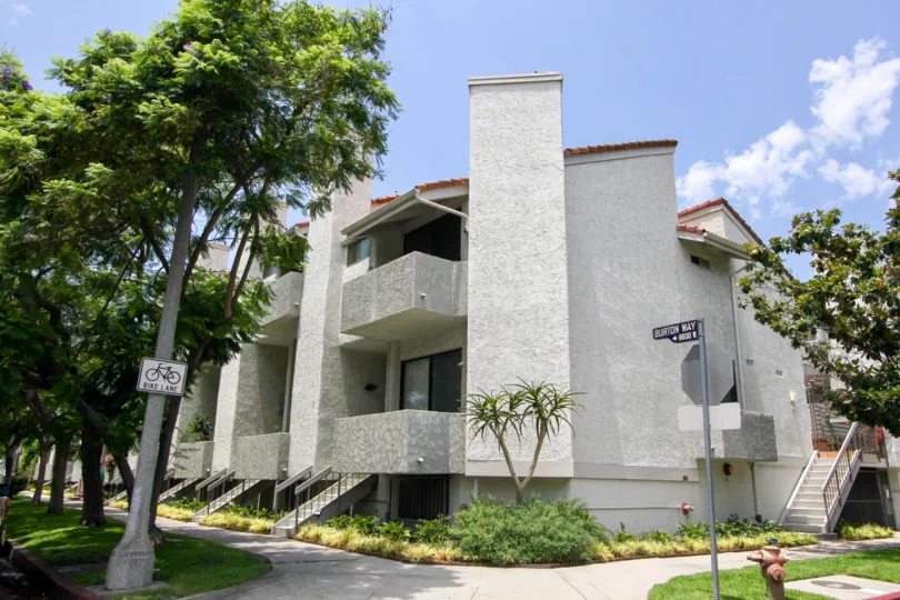 A sunny day at the Sherbourne Villas with quiet sidewalks and trees.