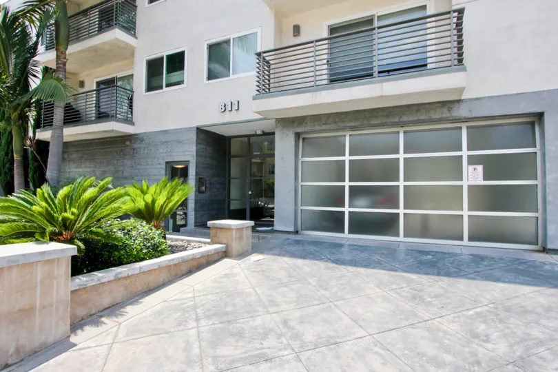 Parking garage entrance at The 811, palm trees, personal terraces, nice landscaping and palm trees
