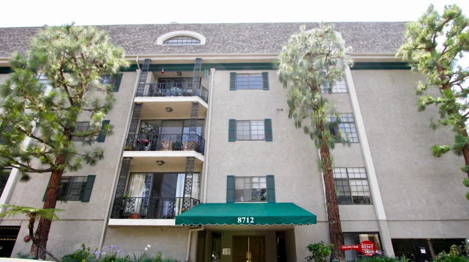 Awning covered entrance and 3 story view of The Gregory building in Beverly Center, California