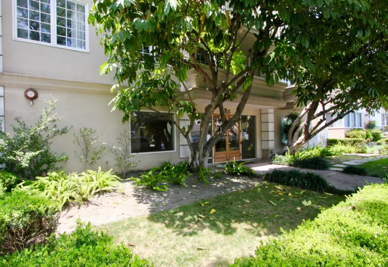 The Haverhills's front entrance is pictured. Two large trees stand on either side of the entrance.