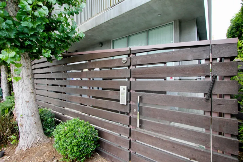 Beautiful rustic porton of dark wood, with sturdy white wood tree in the entrance