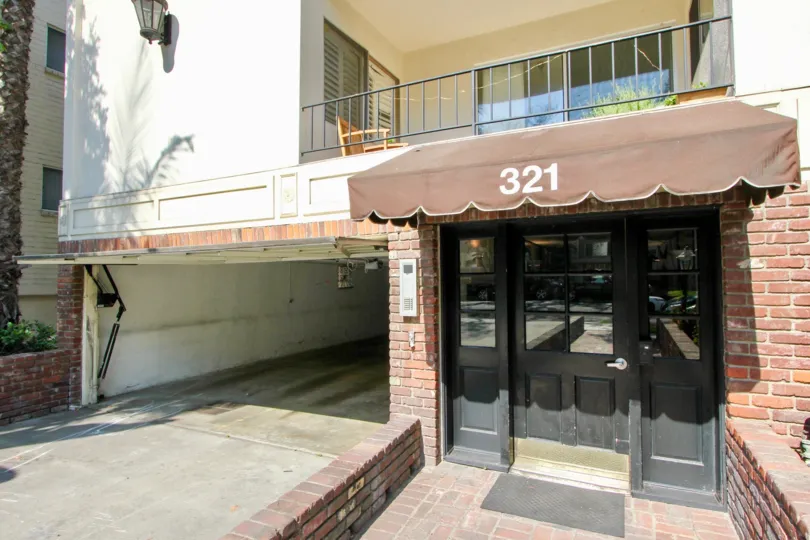 A weathered awning and garage entrance at 321 N Palm Dr.